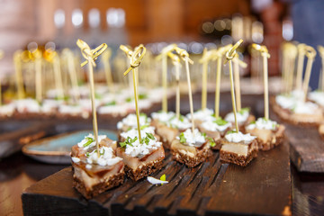 Slices of herring lay on   black bread. Russian canapés