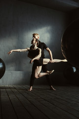 Fototapeta na wymiar Concentrated pleasant ballet dancers performing in the studio