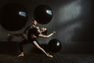 Skilled gymnasts stretching in interaction with each other