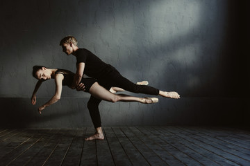 Skilled proficient ballet dancers demonstrating their flexibility
