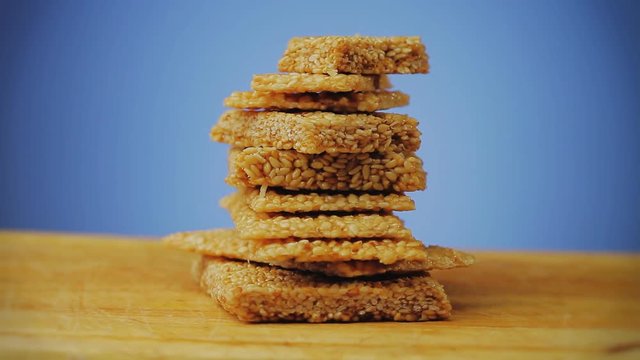Sesame candy called Pasteli on a wooden board