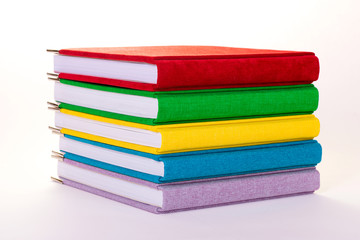 Multicolored book textile cover. Photobooks on a white background.