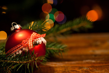 red Christmas decoration in front of burning fireplace and holid