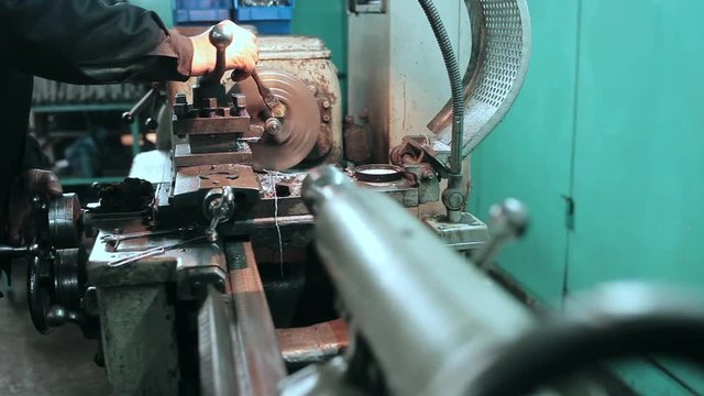 mechanic using industrial lathe machine