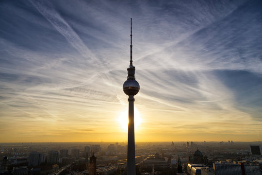 Berlin, Germany - December 2016: TV Tower "Alex" with beautiful sunset, panoramic view onto Alexanderplatz. It is one of Berlin's most famous landsmarks and is the tallest structure in Germany.