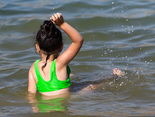 Girl swims in the lake