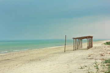 Wooden bungalow on the azure tropical seaside sunny day