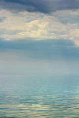 Fototapeta premium Gloomy skies over mirrored surface of the sea