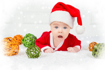 Funny Christmas baby in Santa Claus costume lying on white background