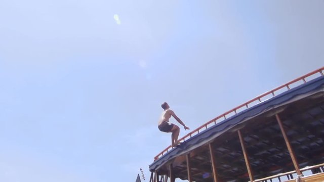 Young Fit Man Jumps Backflip Off The Boat