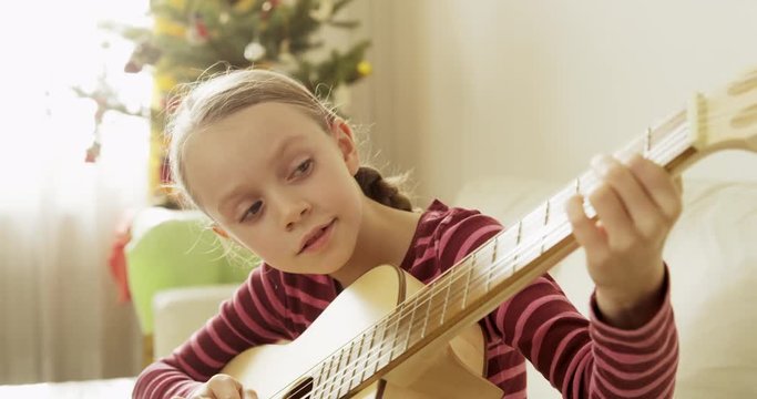 School Girl Learning To Play Guitar