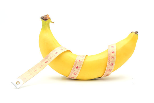 Measuring tape wrapped around a banana isolated on a white background, Concept of diet.