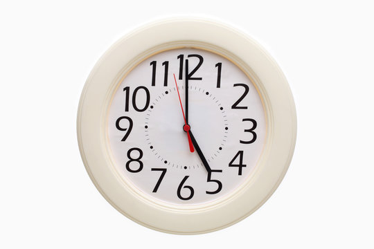 Analog wall clock showing 5:00 o'clock