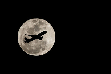 Super full moon over Thailand and silhouette of airplane on Nove