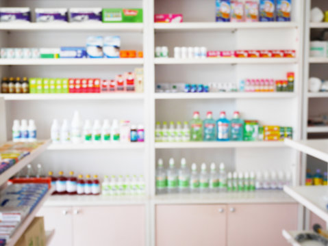 pharmacy store with blur medicines arranged on shelves
