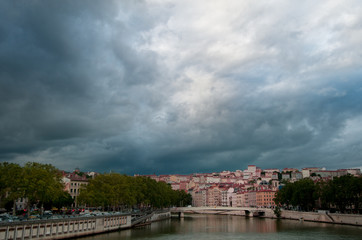 Storm Clouds loom over the cityscape of the city of Lyon and the River Soane.