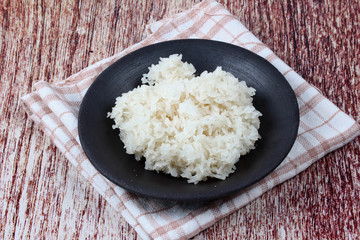 Ready sticky rice served on bamboo background.