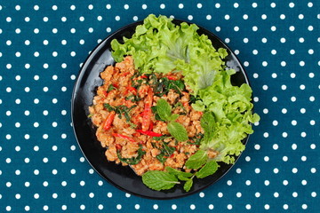 Fried spicy basil with minced pork topped lettuce.