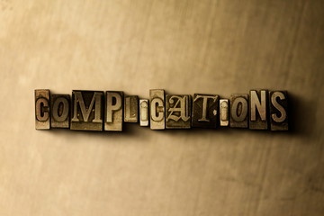 Fototapeta na wymiar COMPLICATIONS - close-up of grungy vintage typeset word on metal backdrop. Royalty free stock illustration. Can be used for online banner ads and direct mail.