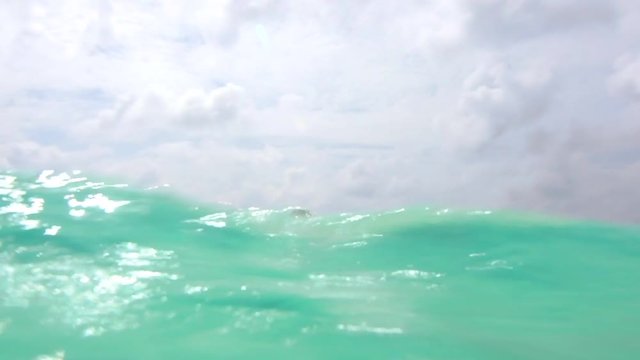 Underwater Shot Of Young Woman Drifting In Sea