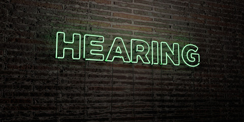 HEARING -Realistic Neon Sign on Brick Wall background - 3D rendered royalty free stock image. Can be used for online banner ads and direct mailers..