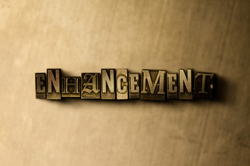 ENHANCEMENT - close-up of grungy vintage typeset word on metal backdrop. Royalty free stock illustration.  Can be used for online banner ads and direct mail.