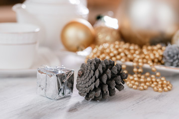 Different kinds cones, Christmas decorations and spruse branch on a wooden background