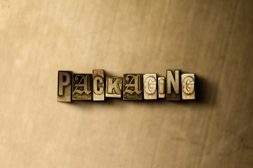 PACKAGING - close-up of grungy vintage typeset word on metal backdrop. Royalty free stock illustration.  Can be used for online banner ads and direct mail.