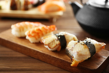 Delicious sushi set on wooden board