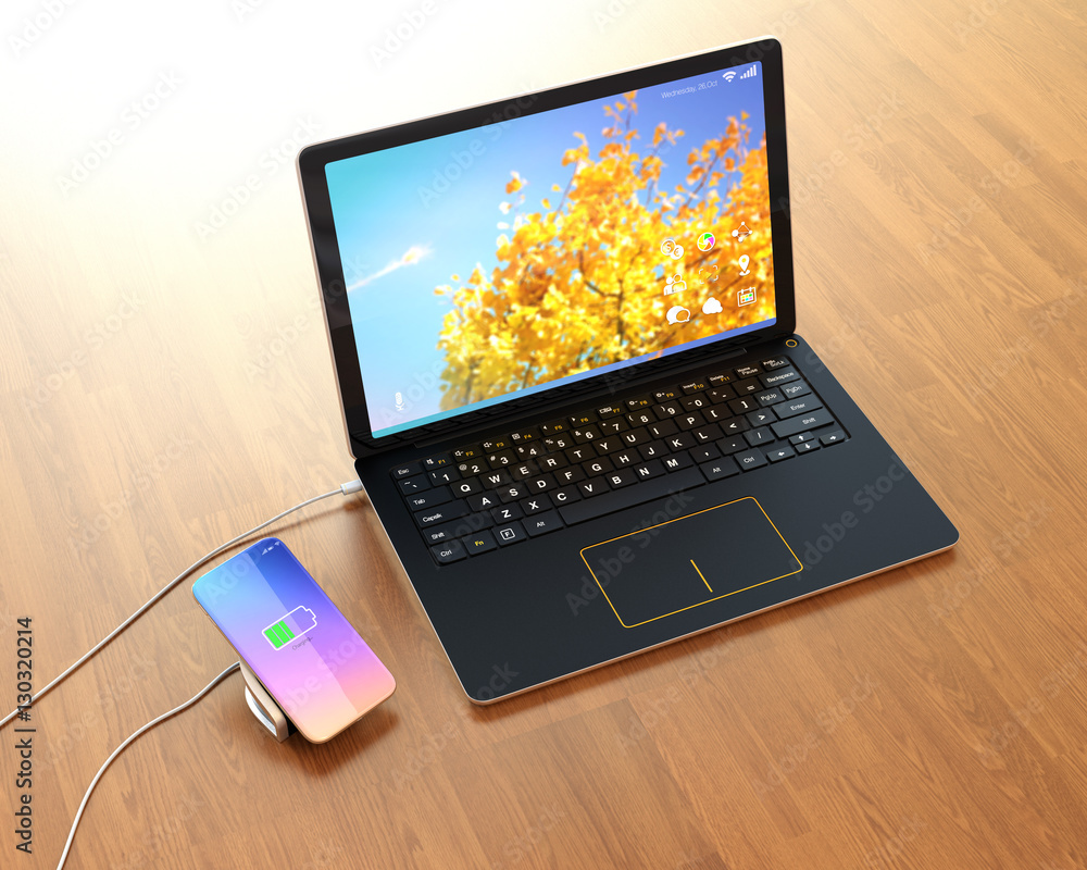 Aufkleber smartphone on a wireless charging pad. the pad connected to a laptop computer. 3d rendering image.
