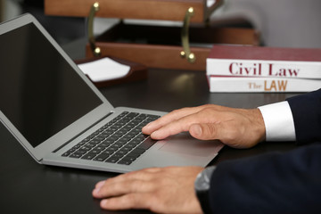 Man working with laptop in modern office