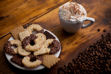 Cup of Coffee with whipped cream and homemade cookies