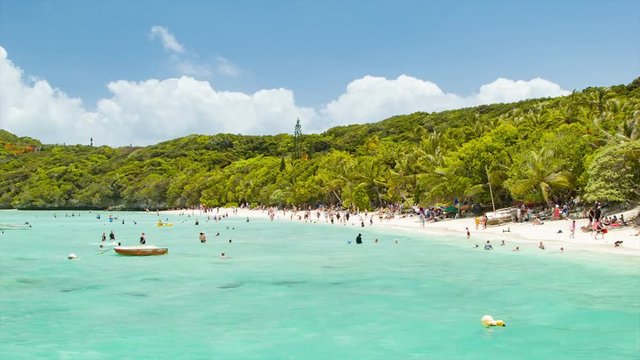 Lifou Island Beach New Caledonia with People Swimming and Enjoying the Sunny Weather
