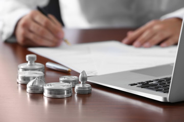 Metal ink pads, stamps and laptop on notary public table