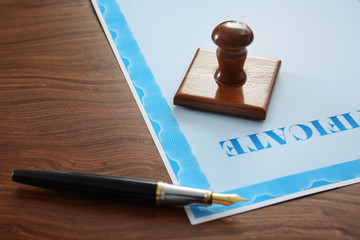 Stamp, pen and certificate on notary public table