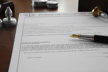 Pen, stamp and document on notary public table