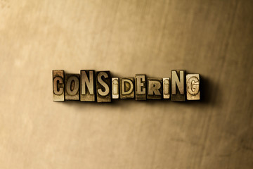 Naklejka premium CONSIDERING - close-up of grungy vintage typeset word on metal backdrop. Royalty free stock illustration. Can be used for online banner ads and direct mail.