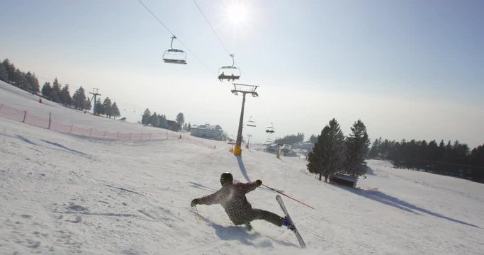 Slow Motion  Of Skier Falling On Ski Slope And Spraying Snow Around Himself