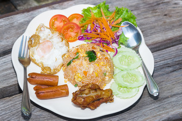 American fried rice on plate on wood table
