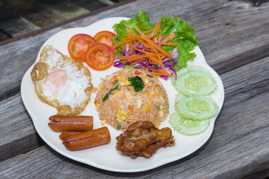 American fried rice on plate on wood table
