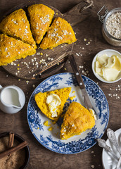 Pumpkin oat scones on wooden table, top view. Flat lay