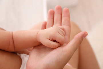 Mother and baby hands, close up view