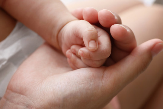 Mother and baby hands, close up view