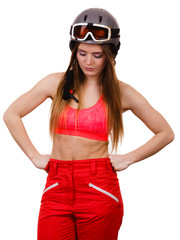 Female skier with arms on hips.
