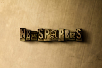 NEWSPAPERS - close-up of grungy vintage typeset word on metal backdrop. Royalty free stock illustration.  Can be used for online banner ads and direct mail.