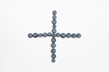 Blueberries in cross shape with white background