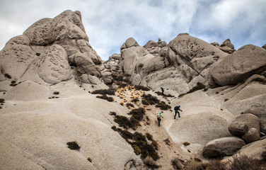 Fototapeta na wymiar Climbers in a boulder field near Bishop, California