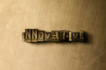 Naklejka premium INNOVATIVE - close-up of grungy vintage typeset word on metal backdrop. Royalty free stock illustration. Can be used for online banner ads and direct mail.