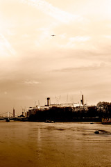 Airplane above Battersea Power Station in London sepia