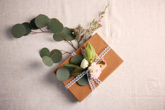 Handcrafted gift box with flowers on table
